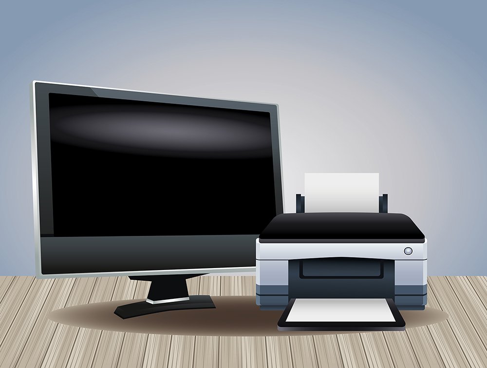 Monitor e impressora sobre uma mesa